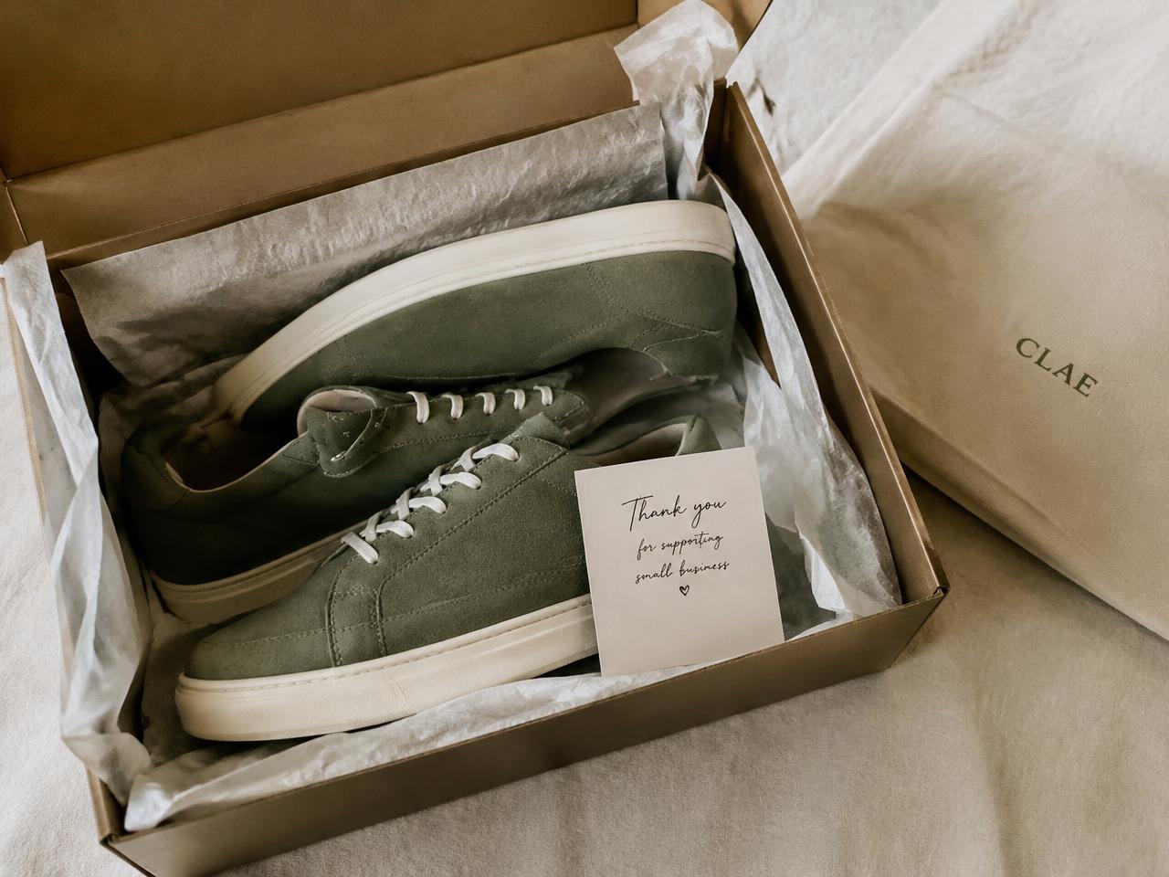 Sneakers in a box with a handwritten thank-you card
